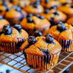 Moist and fluffy blueberry protein muffins with fresh blueberries on top