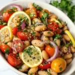 How to Make the Best Marinated Zaatar Bean Salad at Home 7 Close-up of marinated zaatar bean salad with cherry tomatoes, red onion, parsley, and white beans.