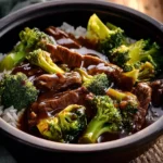 Tender beef slices and bright green broccoli florets in glossy savory sauce over white rice
