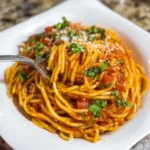 Instant Pot spaghetti with meat sauce in a bowl topped with basil and parmesan