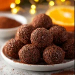 Festive orange chocolate Christmas truffles on a holiday platter.
