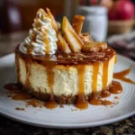 Creamy apple cider cheesecake topped with apple glaze and cinnamon.