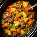 Hearty beef stew with carrots and potatoes in a rustic bowl.