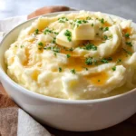 Best mashed potatoes served with creamy butter and fresh chives.