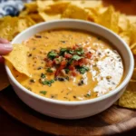 Warm Cowboy Queso dip served in a skillet with tortilla chips