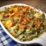 Creamy green bean casserole with golden potatoes baked in a dish