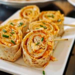 Buffalo Chicken Tortilla Pinwheels on a platter with dipping sauce