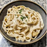 Creamy homemade Alfredo sauce in a white bowl