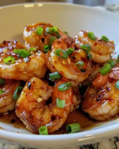 Delicious high-protein honey garlic shrimp dish garnished with herbs