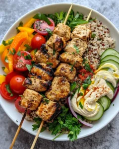 Mediterranean Bowl featuring grilled chicken tawook skewers and fresh ingredients